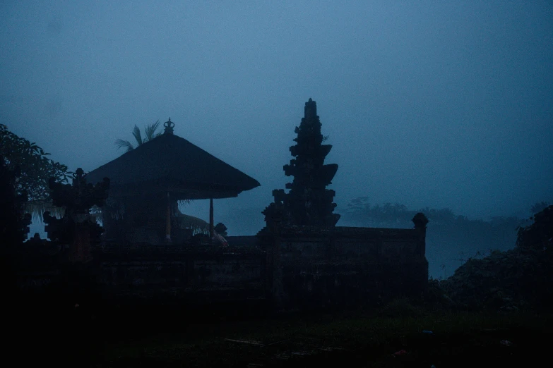 silhouette of buildings with dark sky and umbrellas