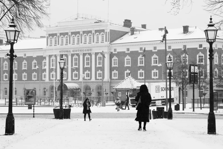 a snowy plaza in front of an old building