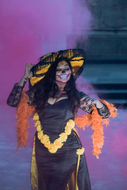 a beautiful woman in skeleton makeup walking with flowers on her head