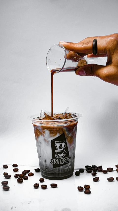 coffee being poured into a cup of coffee