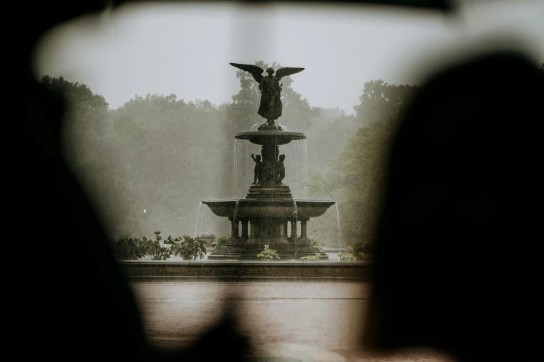 a statue is shown in the fog and water