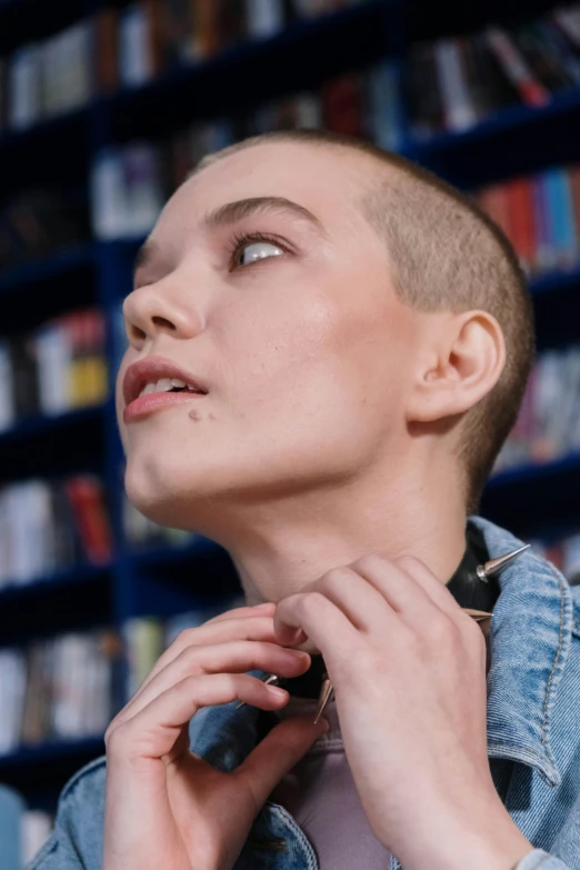 a woman standing with her hand on her neck