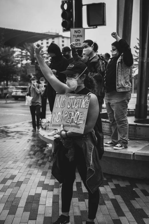 black and white pograph of person holding sign