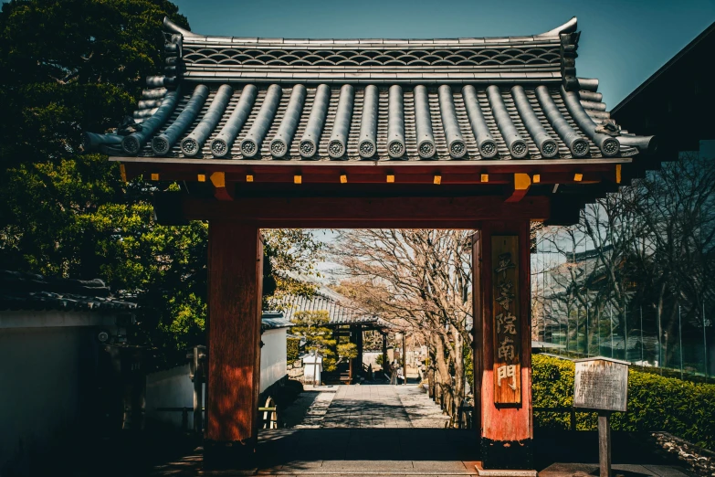 an entrance to a small building with a tree in the distance