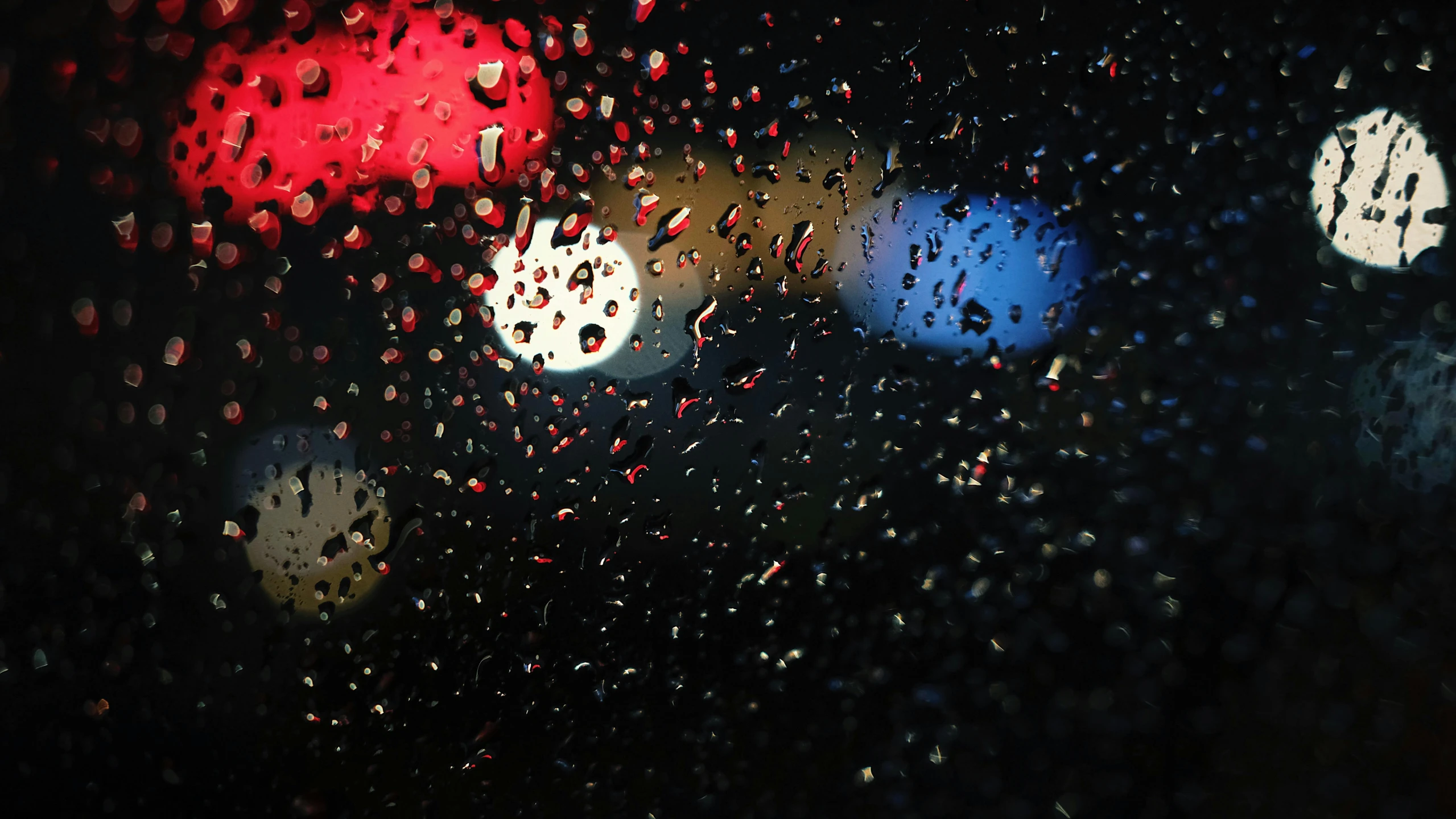 a traffic light with rain droplets on it