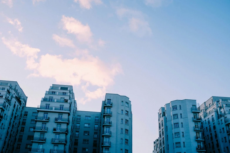 some very tall buildings with windows and blue sky