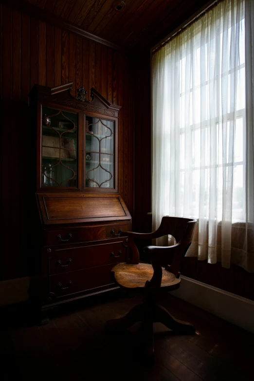 an old fashioned dresser sits in front of a window