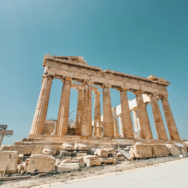 the ancient ruins of a temple stand against a blue sky