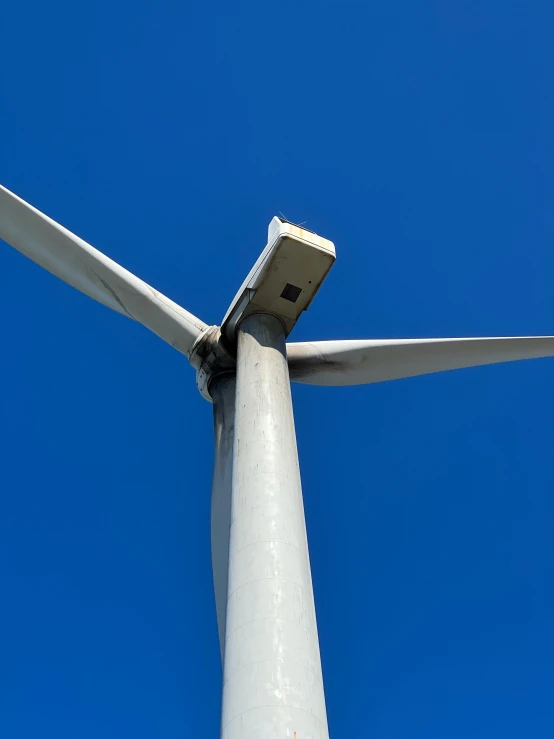 a windmill spinning with the blades missing on top of it