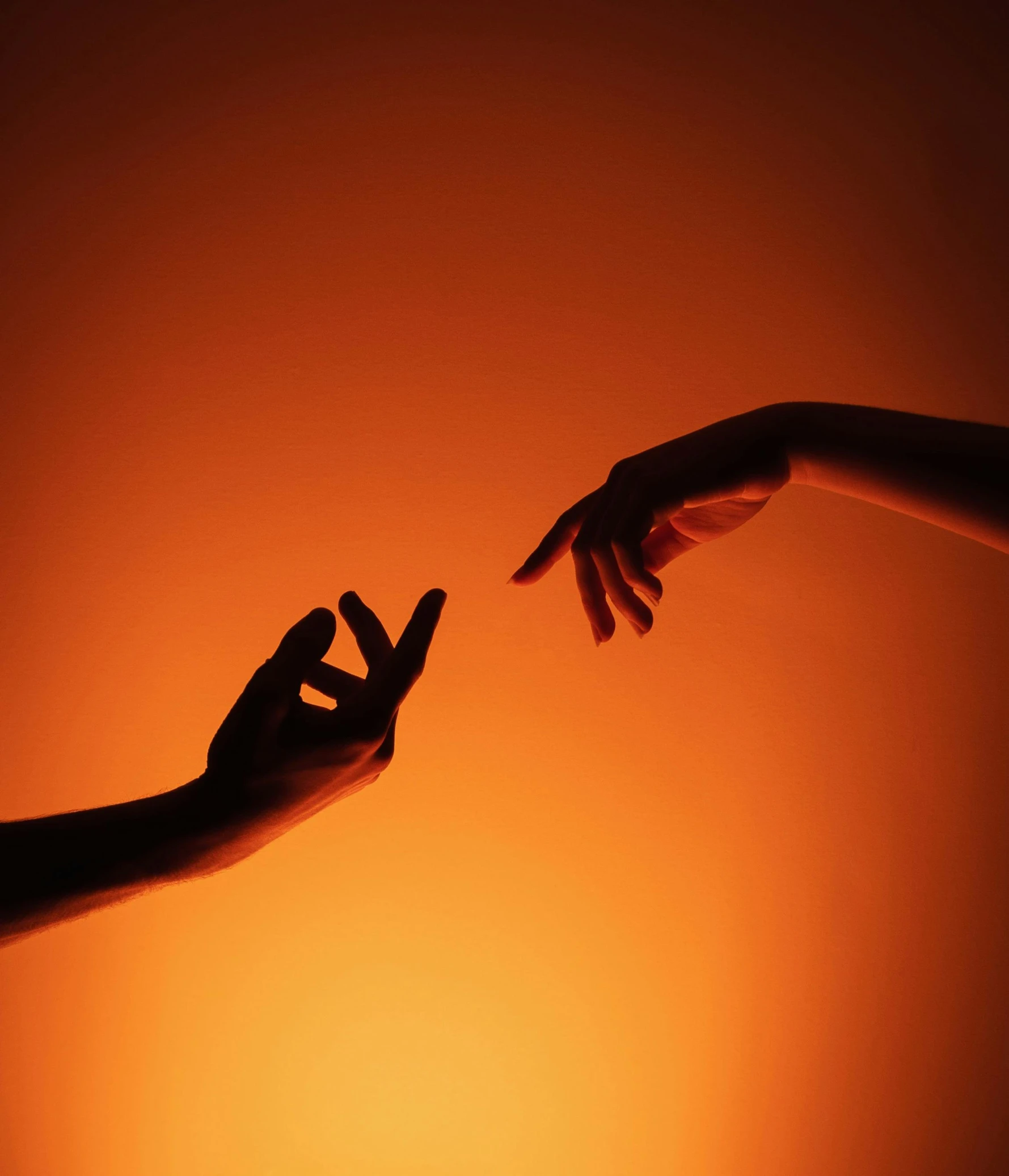 two hands reaching towards each other to reach for a second