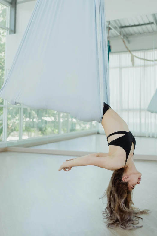 a woman on one side of a hammock and on the other