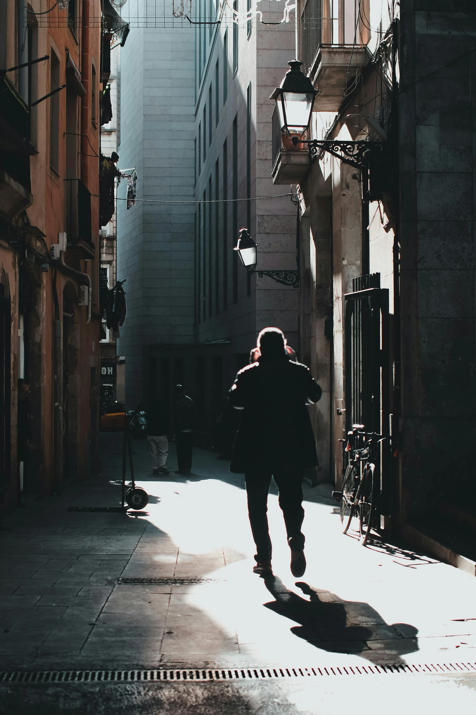 person walking down alley way, in residential area