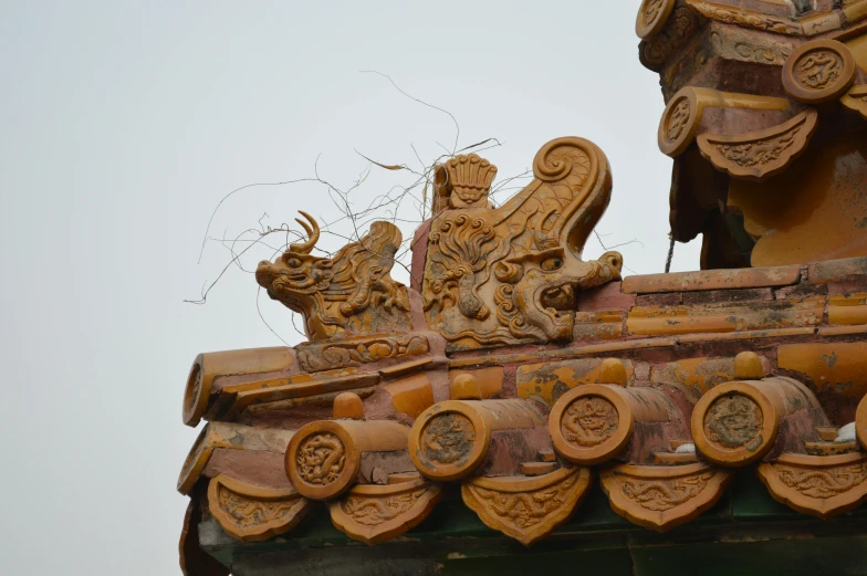 a decorative object on a building with two birds perched on top