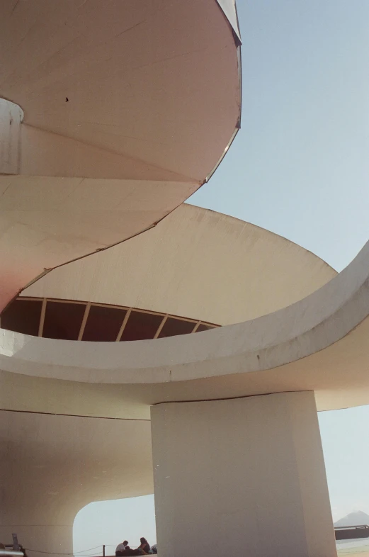 a view of a building, with people walking on it