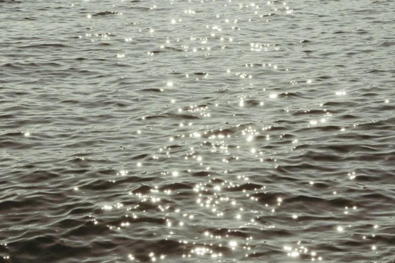 small white bubbles fill the water from a boat