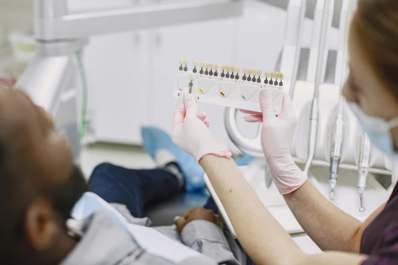 a female patient is holding a piece of medical equipment