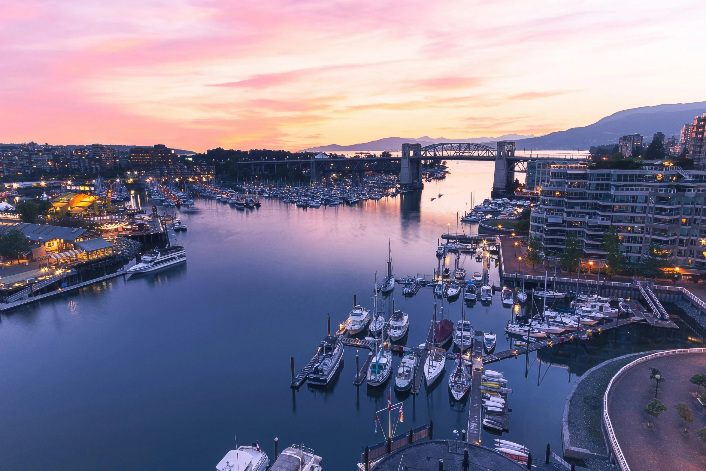 a harbor full of boats at dusk time