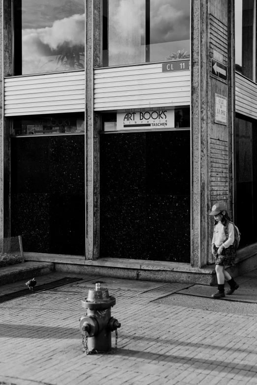 a black and white po of a fire hydrant in front of the storefront