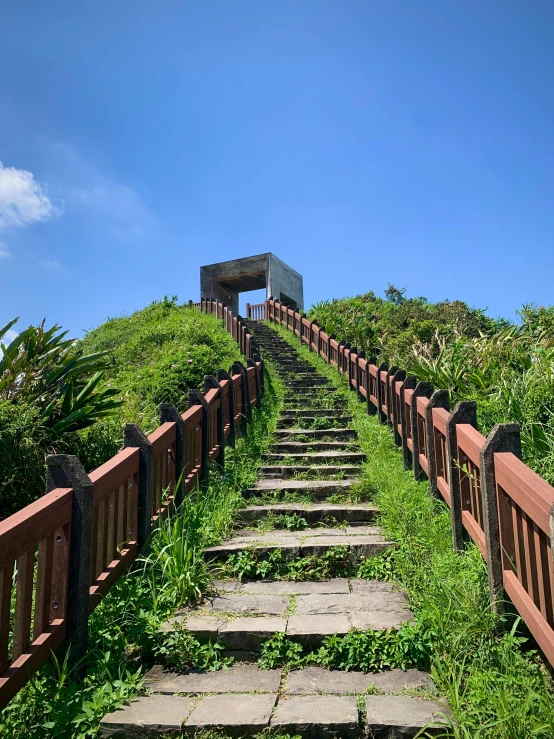 the stairway is made from stone steps and wooden railings