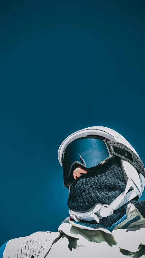 a skateboarder's helmet atop his shoe, on the side of a wall