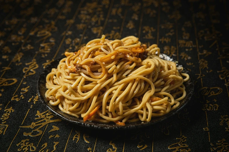 a plate filled with pasta and sauce on top of a table