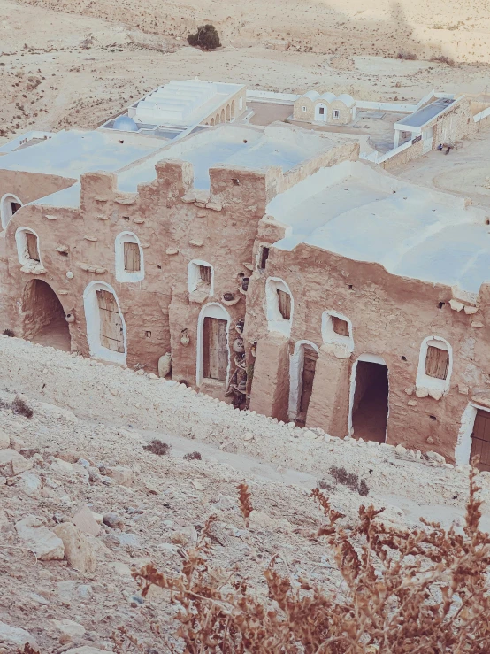 the building is made out of brick, but with small windows