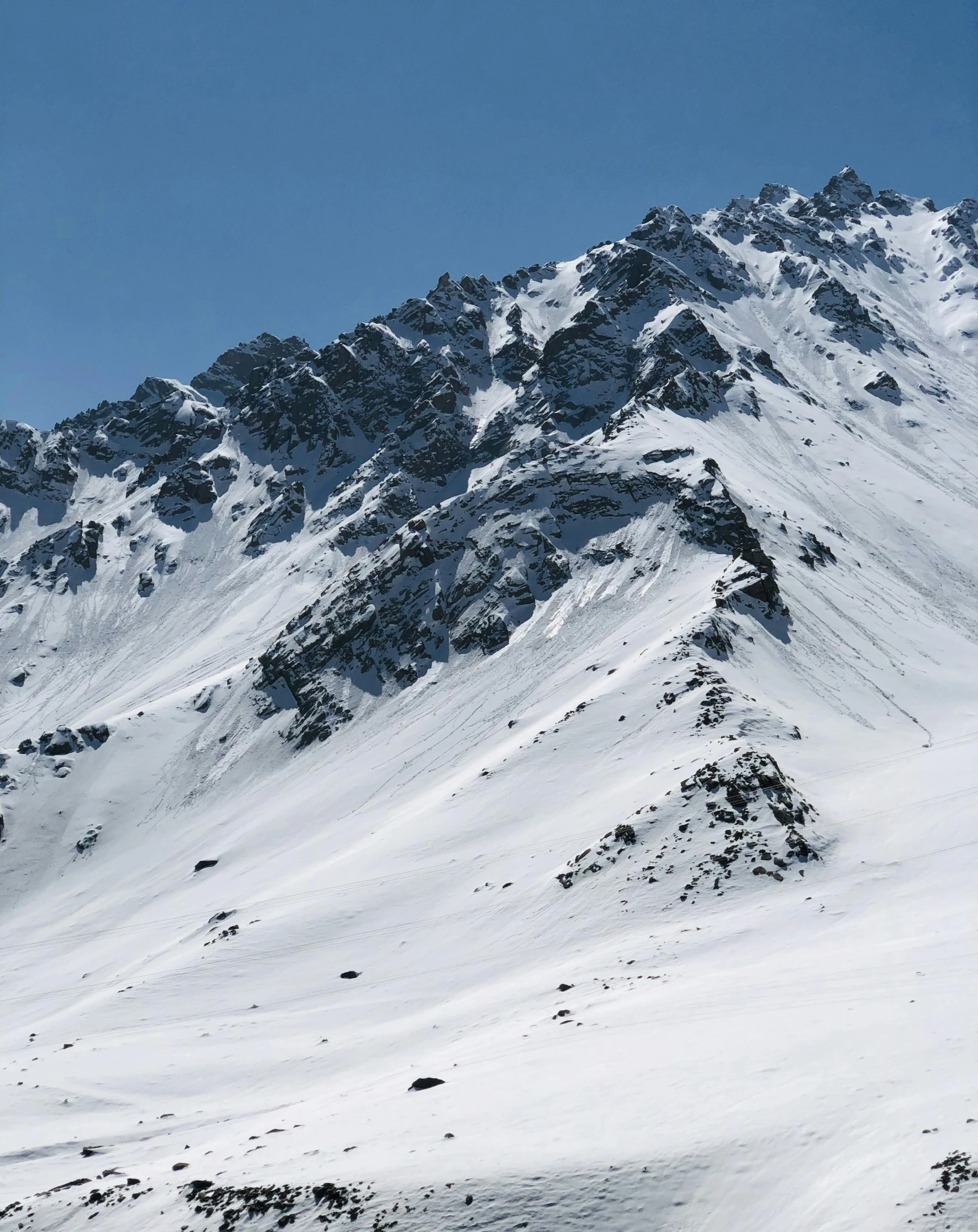 a skier going down the mountain on a sunny day