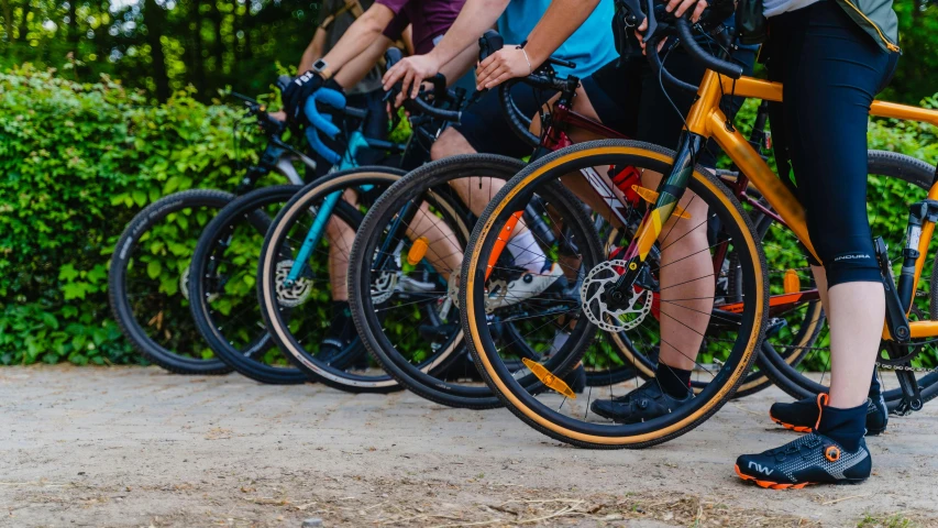 a group of people standing next to each other with bikes