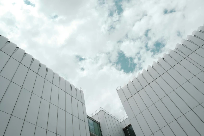 white modern buildings against a cloudy sky