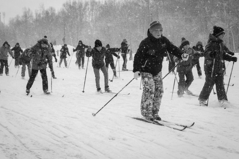 a crowd of people on skies standing in the snow