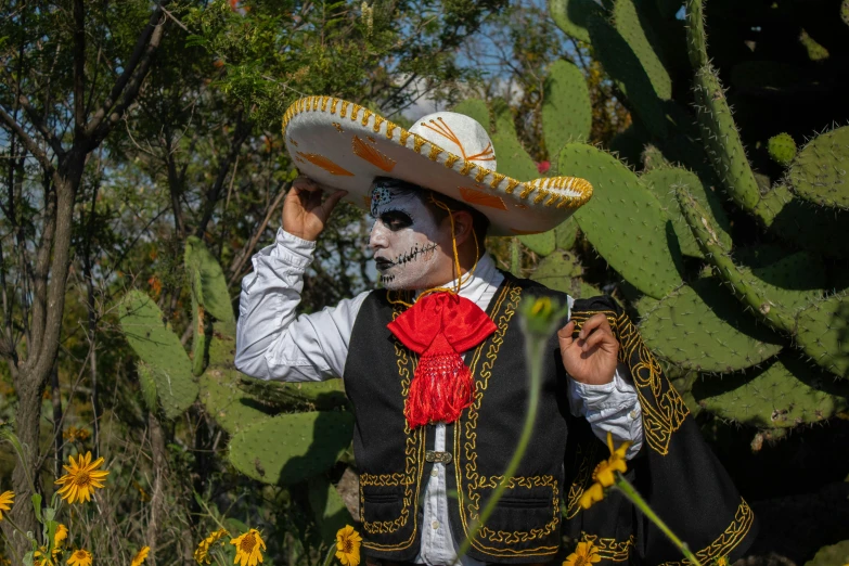 mexican man with face painted in black and white and a red tie