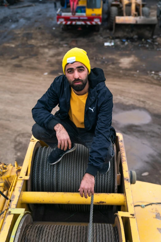 man sitting on back of tractor in construction site