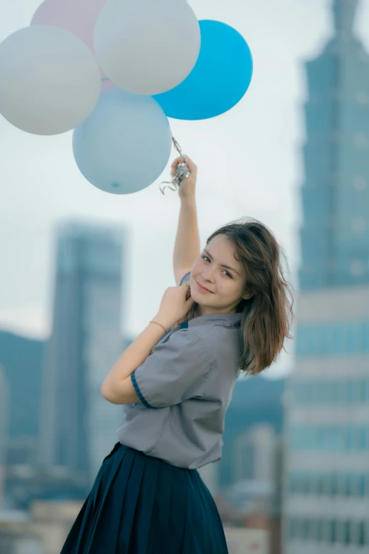 a  holding several balloons in her hand