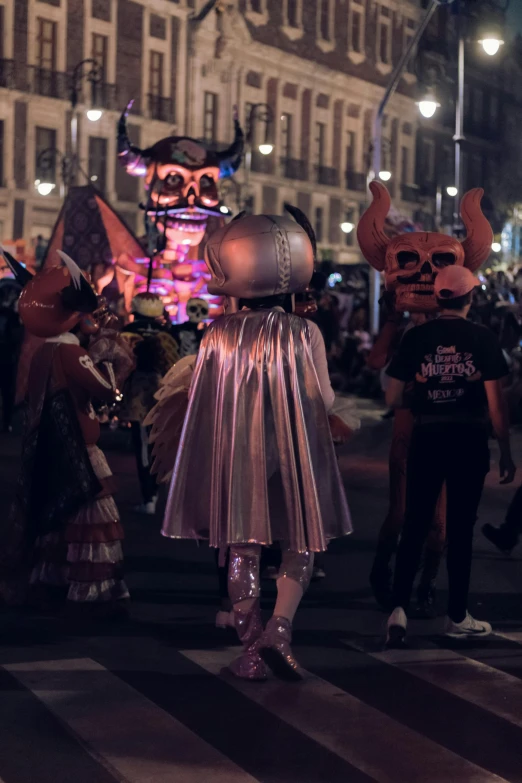 some people walking down the street with costumed items