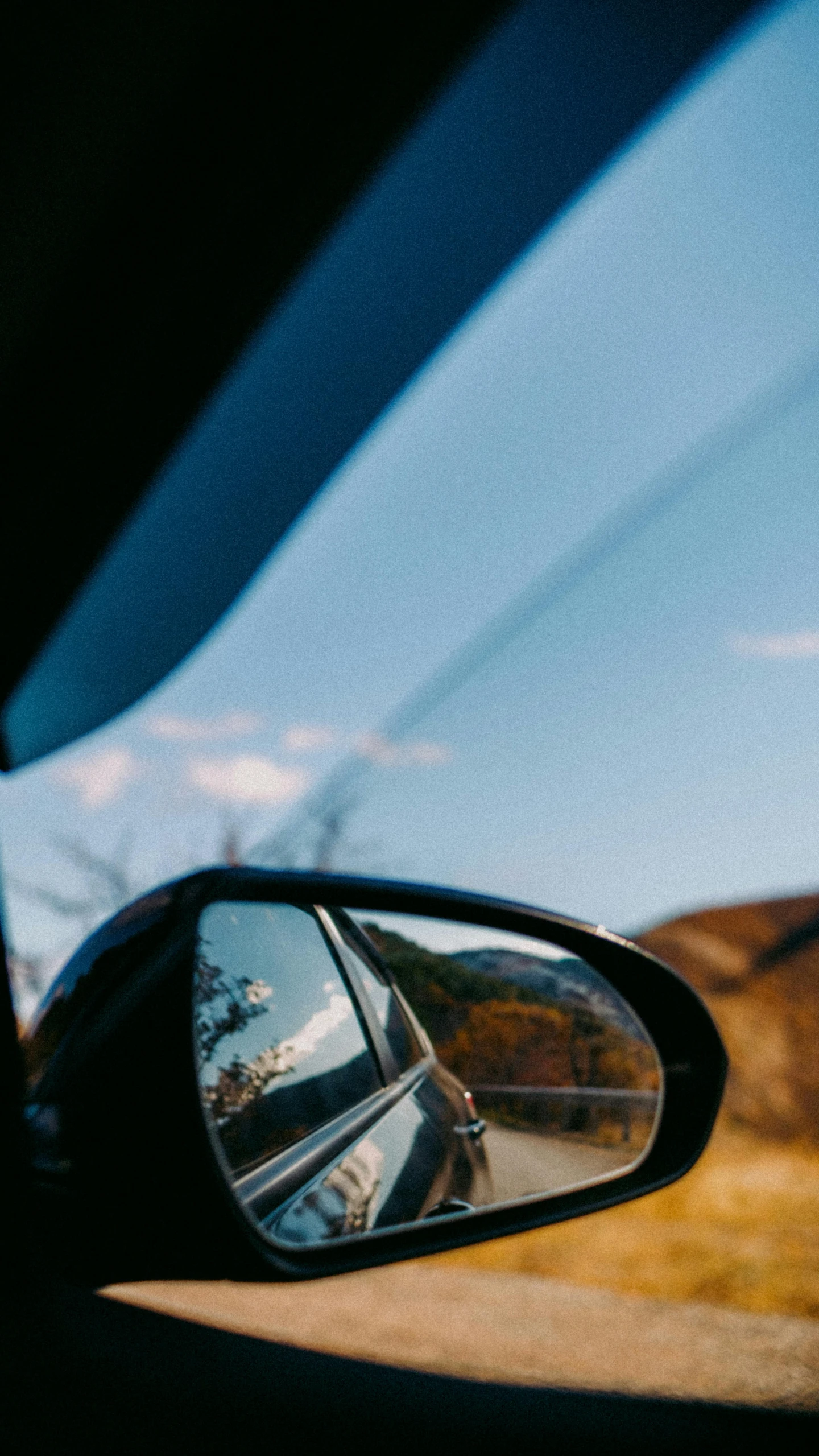 the side mirror of a car with a car on it