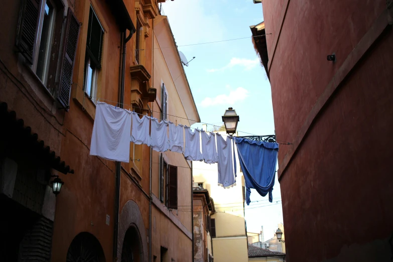 laundry hanging on a line outside of a building