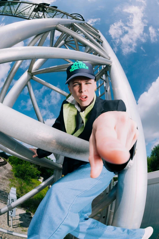 a man in a hat standing on a metal structure