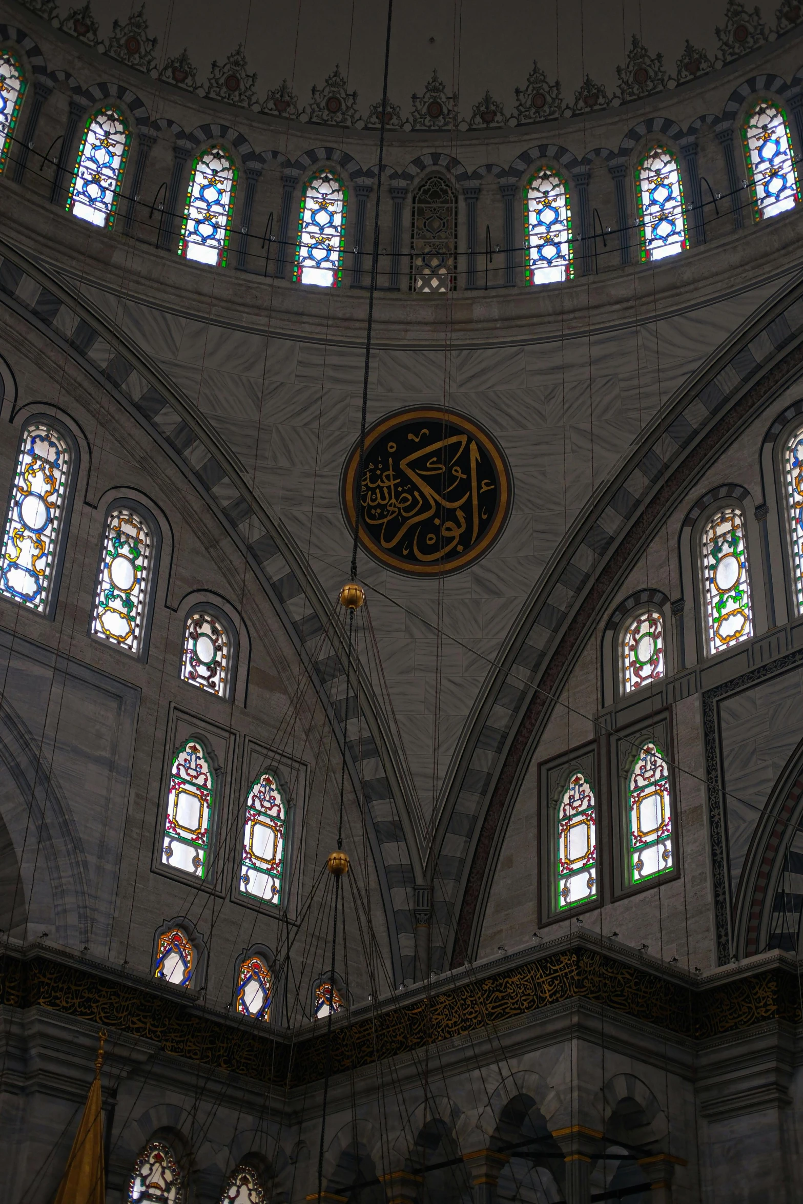 the interior of an oriental structure with many stained glass windows