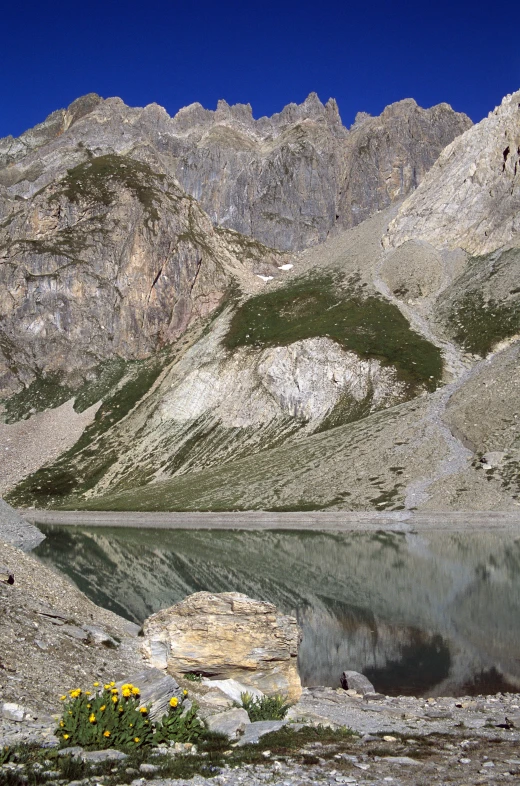 the rocky mountains are reflected in the water