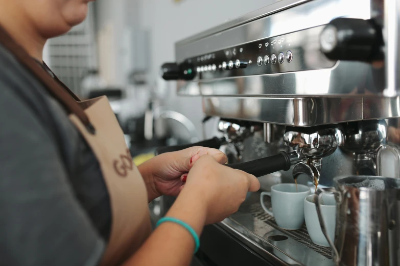 a close up of a person serving cups of coffee