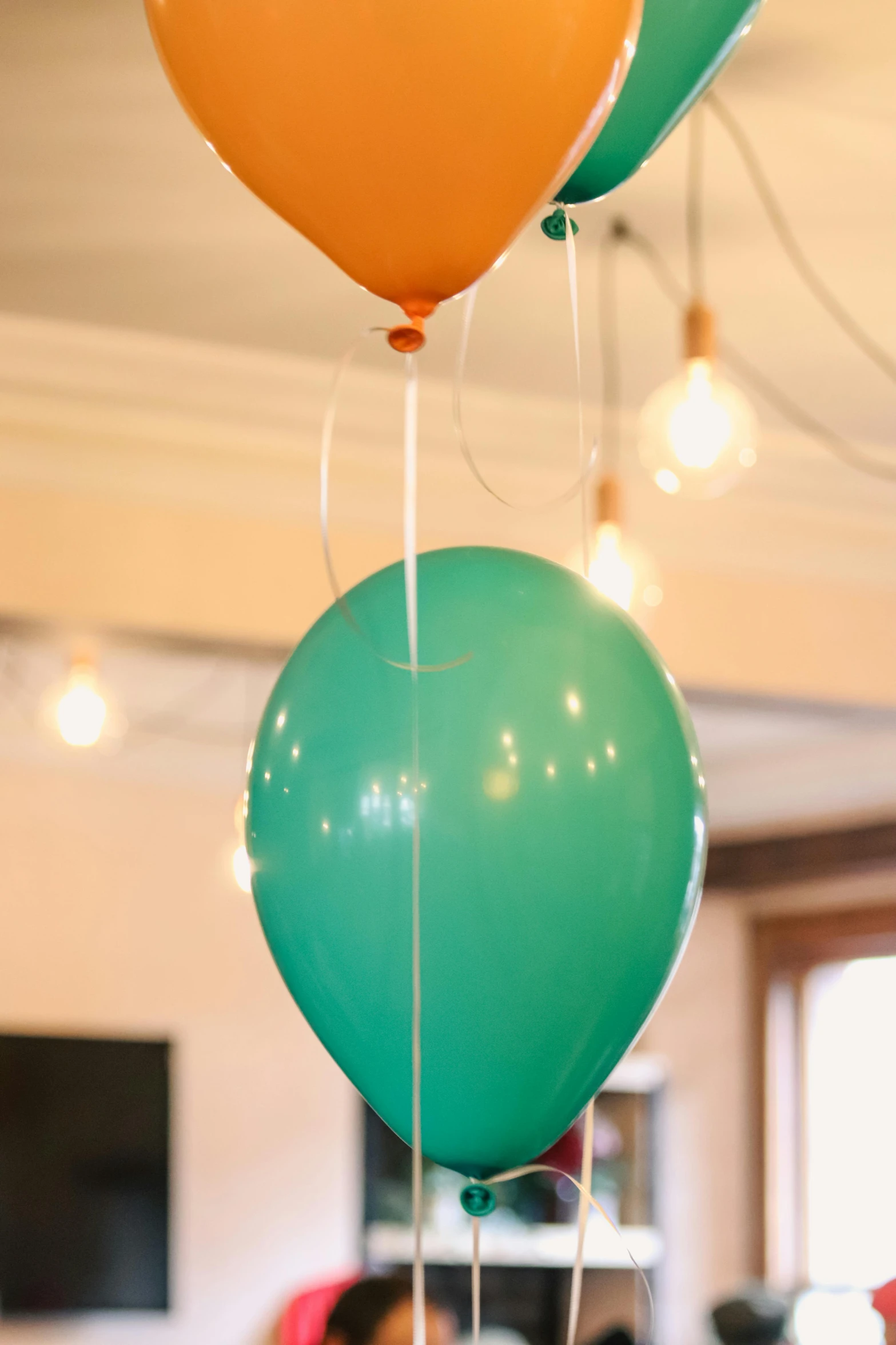 three balloons on the ground with streamers attached