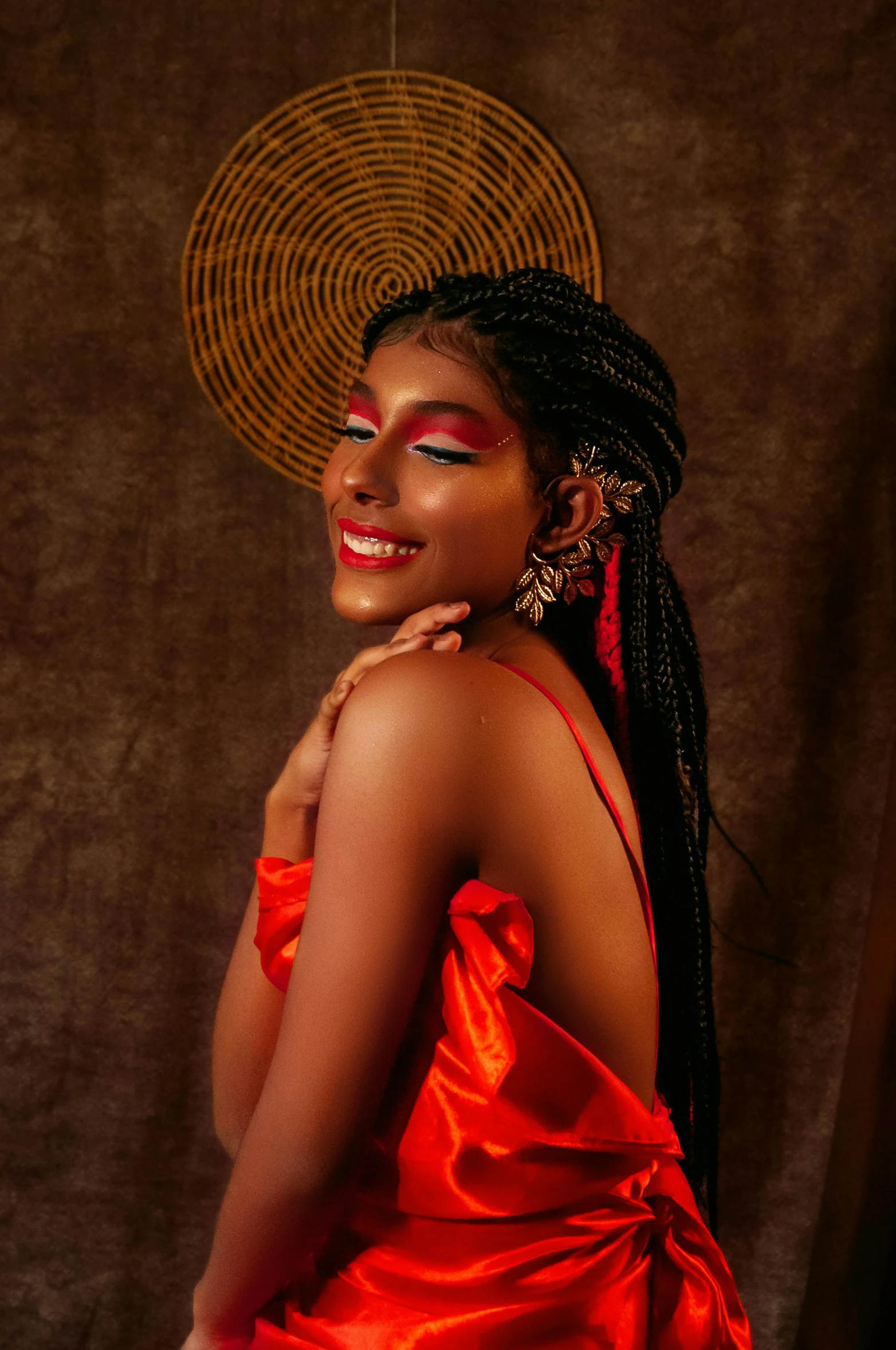 a beautiful young woman wearing a bright orange dress and a straw hat