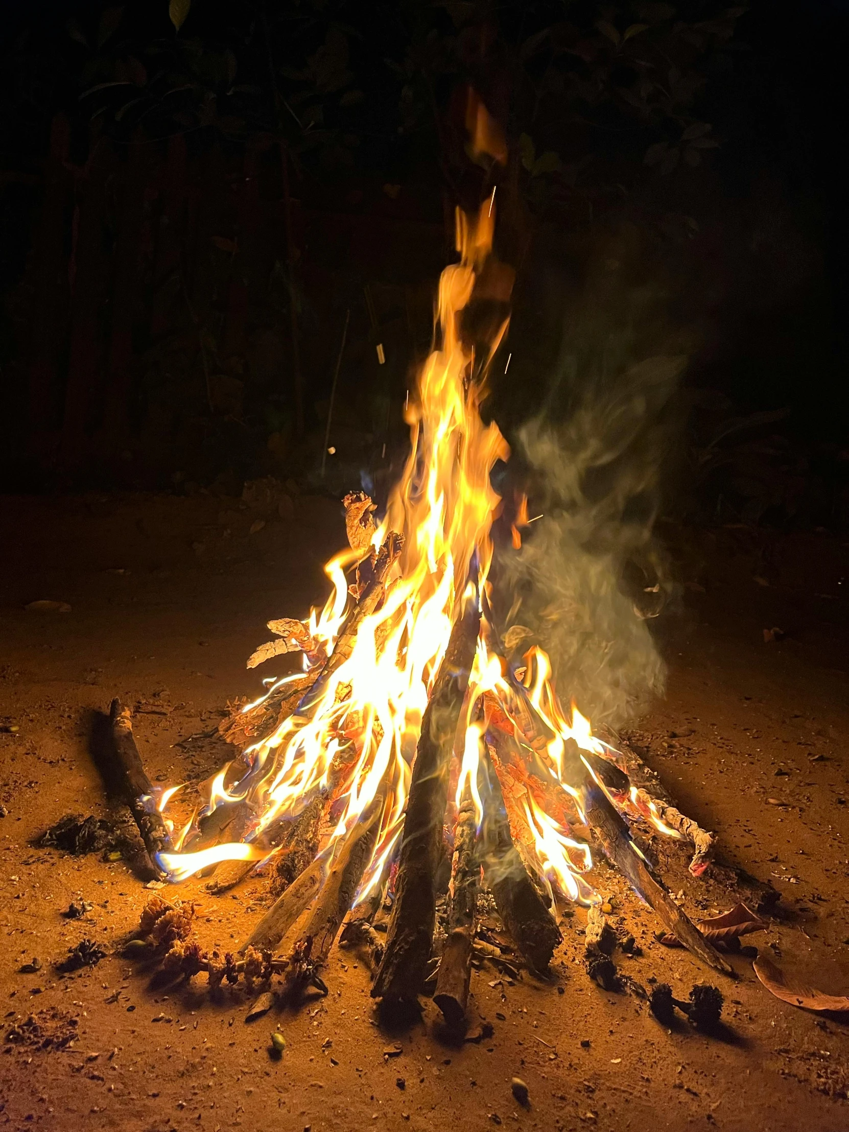 a large open fire on a dirt field