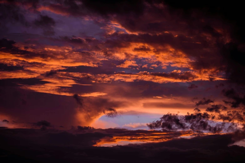 a beautiful pink sky with a few clouds on it