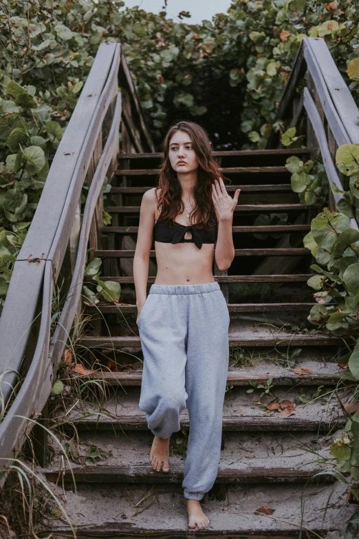 a woman is posing for a po on the stairs