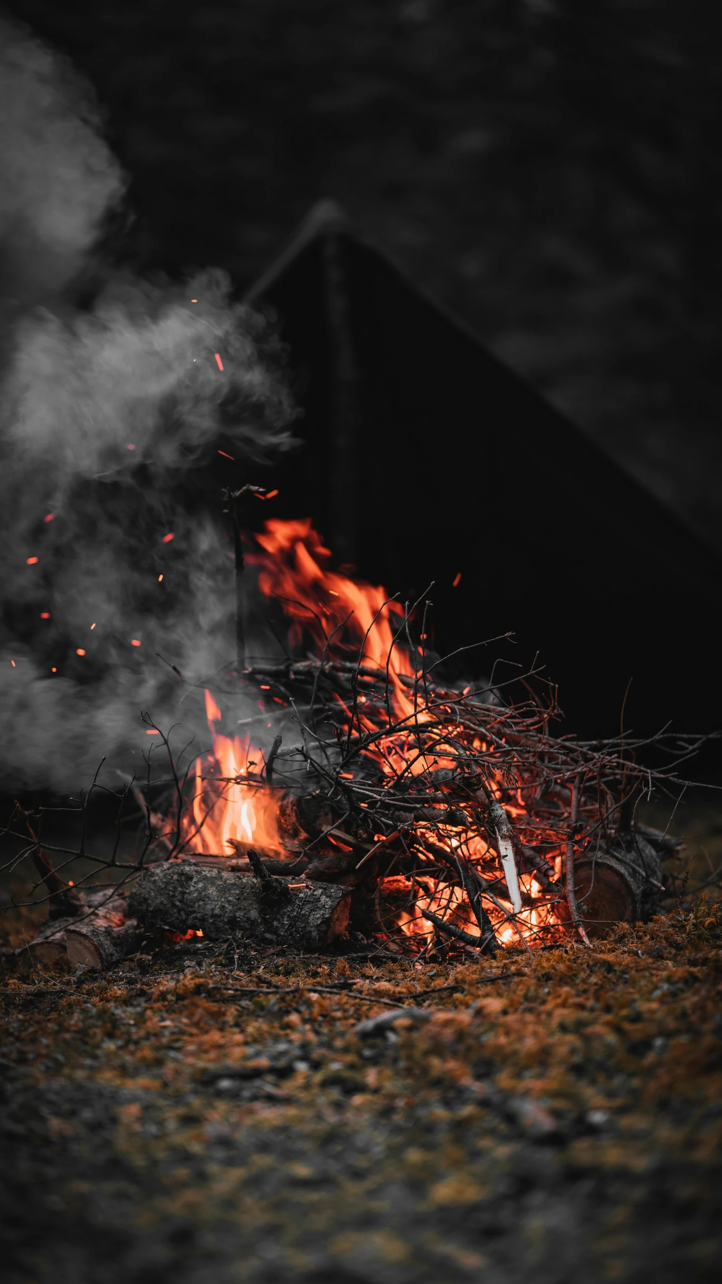 a grill of fire burning in a black background