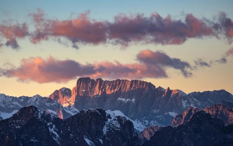 a beautiful mountain covered in snow at dusk