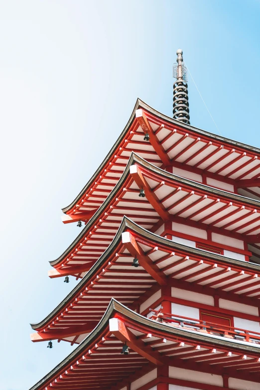 a building with red trim and a blue sky behind it