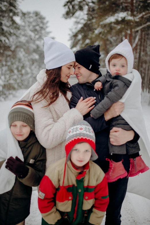 two mothers and their children in the snow