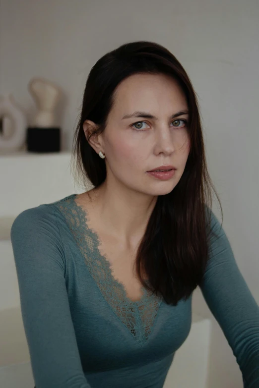 the young woman is sitting and posing for the camera